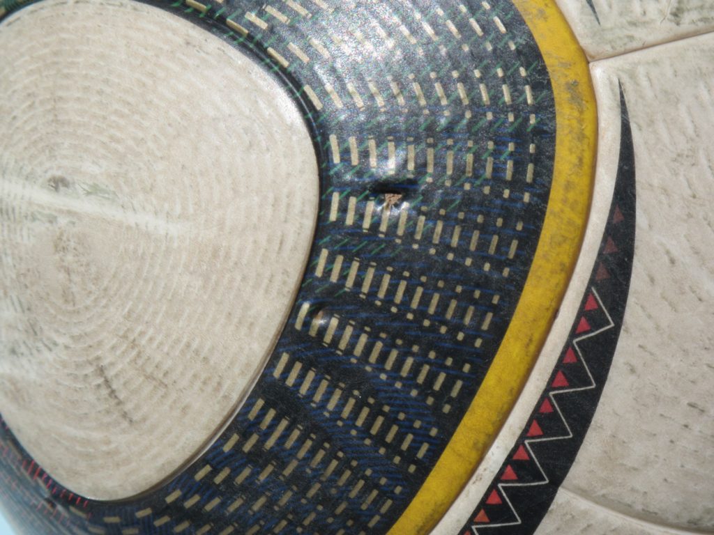 Adidas Jabulani with a puncture mark.