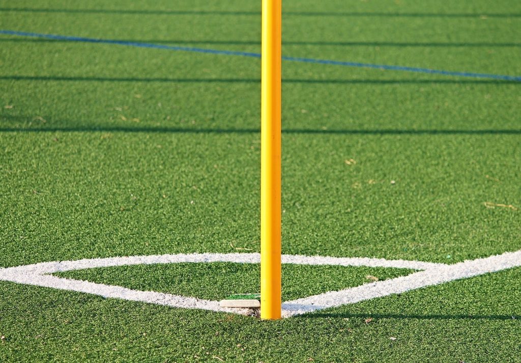 The corner flag on an artificial soccer pitch.