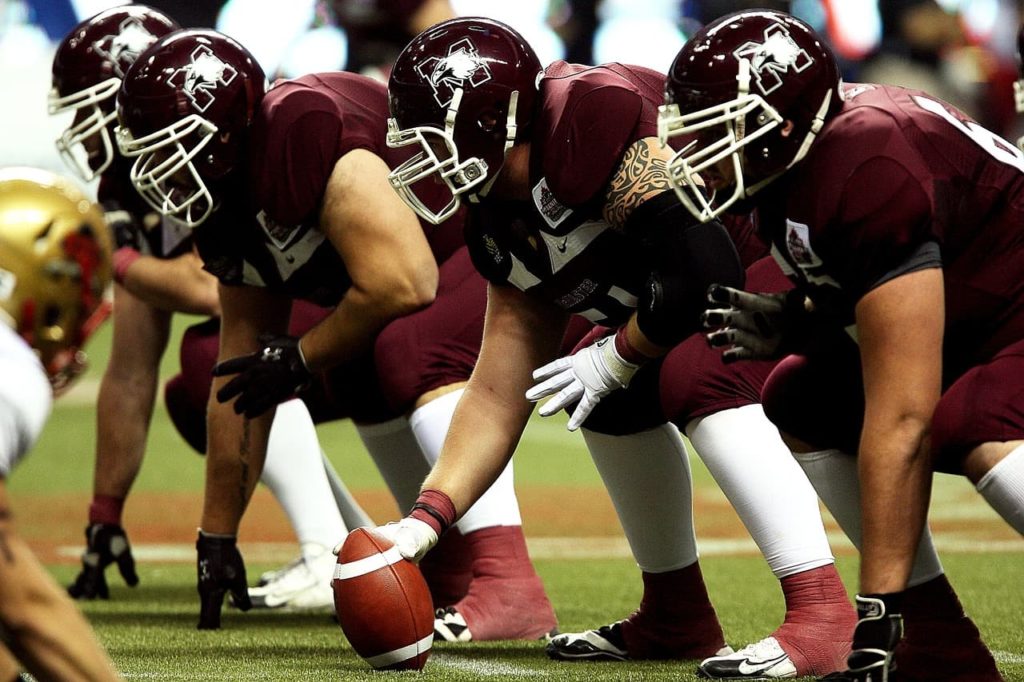 A lineman using a football.