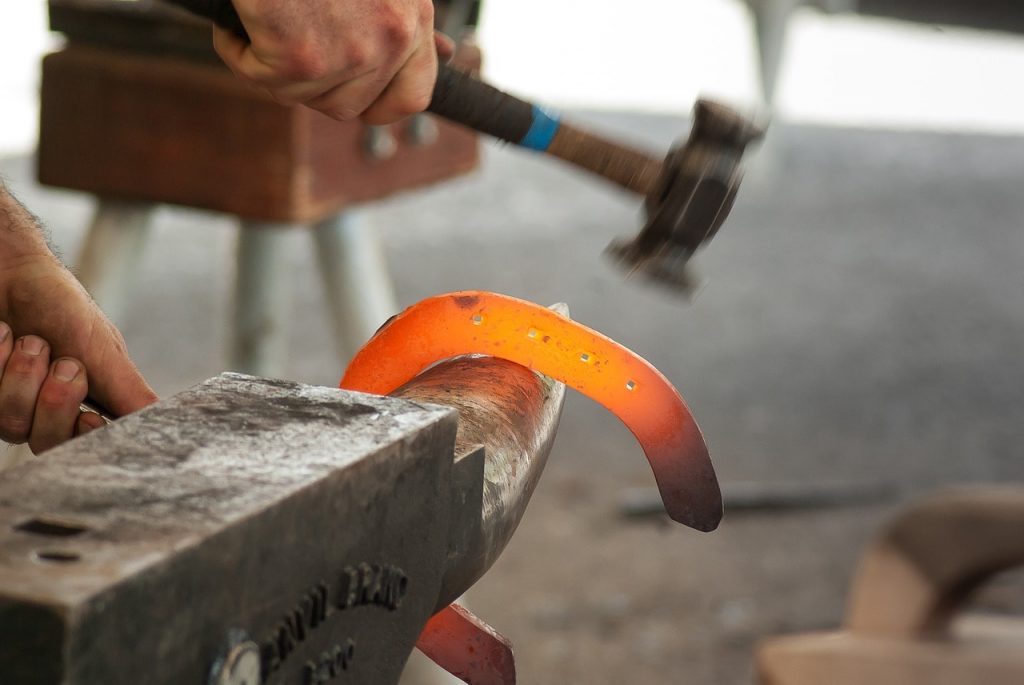 A horseshoe being forged by a blacksmith.